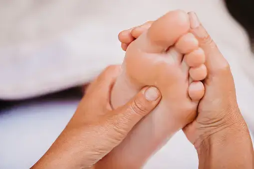 Client receiving a relaxing reflexology treatment